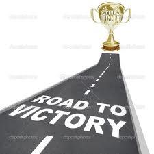 Trophy on a road with the words 'Road to Victory'